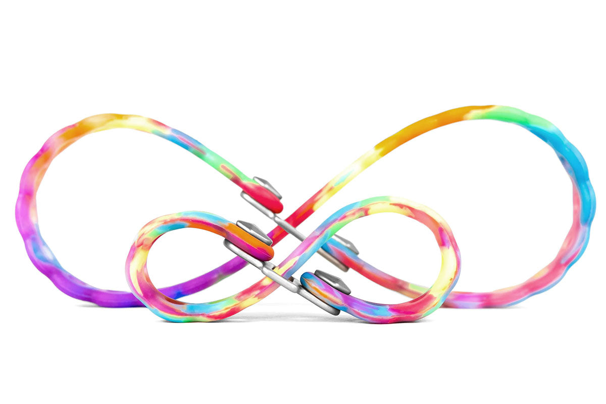 Studio image of tie dye infinity rubber ties linked together in a figure eight shape with silver metal clasps.