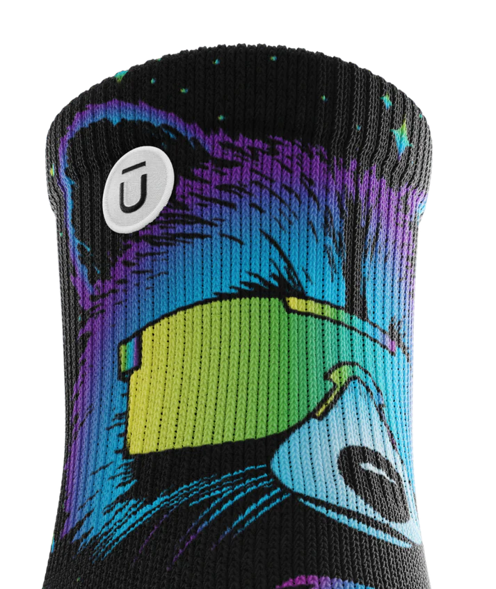 Top cuff of Pair of black sock with heads of racoons wearing sunglasses. Racoon has blues, purples, teals, and yellows, background is black. Circular white patch with Outway logo on top third of cuff