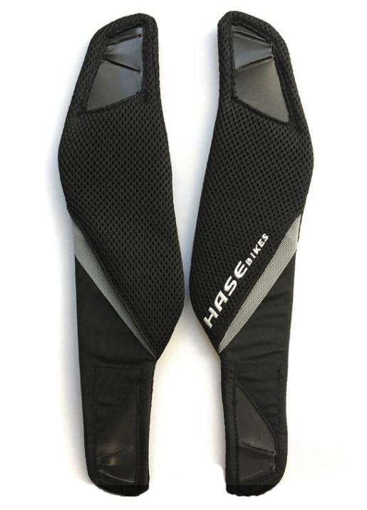 A pair of black mesh shoulder pads labeled “HASE BIKES” are shown on a white background. The pads are part of a harness system, designed for comfort and support.