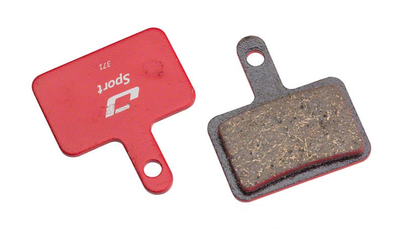 Jagwire Mountain Sports Semi-Metallic Disc Brake Pads, showing the back and the front of the brake pads in the picture, the back is red.