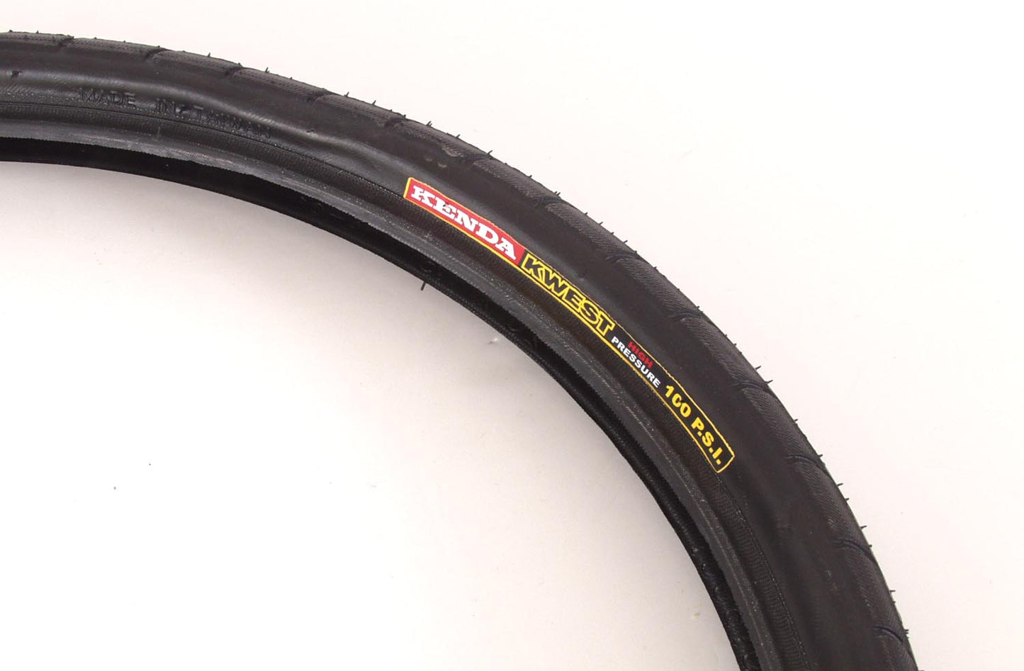 Black Kenda Kwest high pressure road bike tire with visible tread and branding.