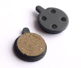 TerraTrike Rover Zoom Disc Brake Pads showing the front and back of the brake pads, white and brown surface
