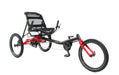 Studio front right profile view of delta style hase trigo recumbent trike with one twenty inch wheel in front and two twenty inch wheels in back, frame is black and red