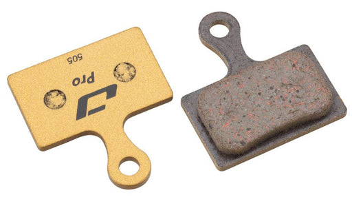 Studio image of two Jagwire Pro Semi Metallic disc brake pads, the one on the left is showing the back side with black lettering saying Pro 505, the right brake pad is showing the composite brake surface