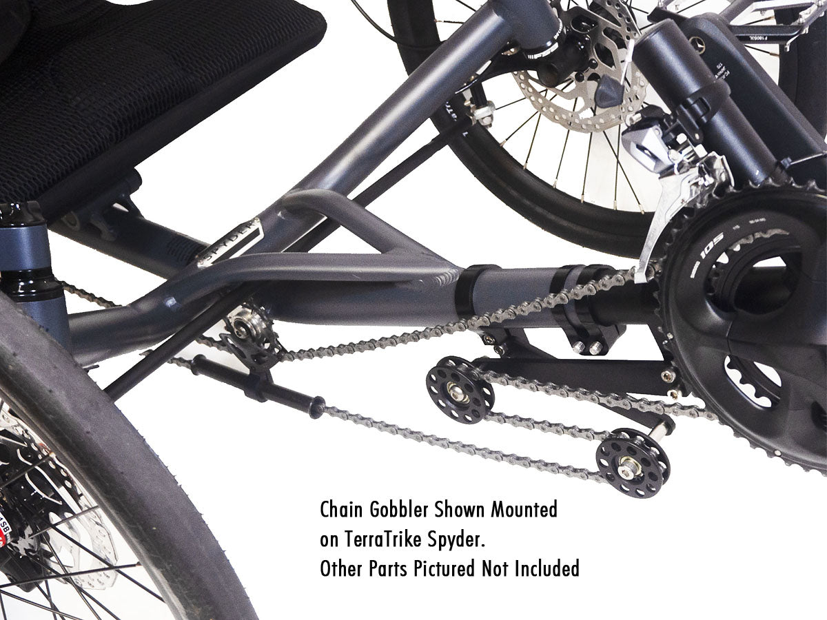 Studio image of the TerraTrike Chain Gobbler installed on a black TerraTrike Sypder recumbent trike. Image has text that reads "Chain Gobbler shown mounted on a TerraTrike Sypder. Other parts pictured not included."