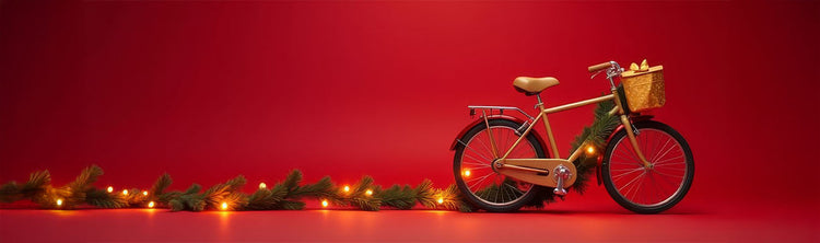 A gold bike and greenery with holiday lights are set against a red background.