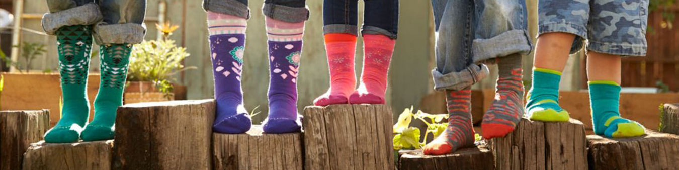 People post on wood stumps in a variety of colorful socks.