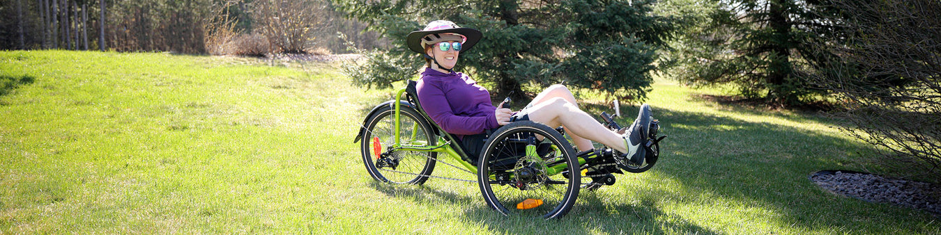 Recumbent sale web banner, ICE Sprint X tour sitting in front of bushes on a paved trail