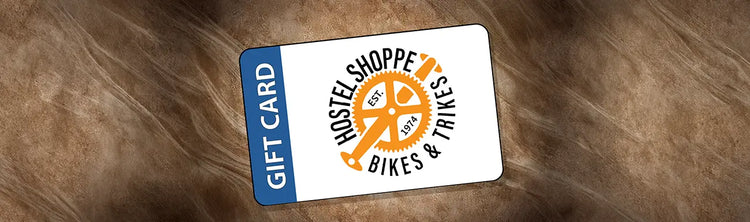 Image of Hostel Shoppe e-gift card against a wooden background.
