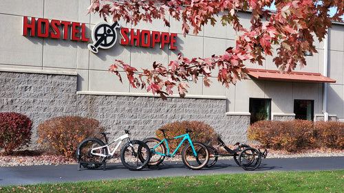 A picture of the Hostel Shopping during fall with some bikes and a trike pictured on the bike path.