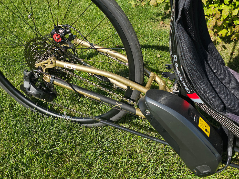 ICE Sprint X 700 Closeup of drivetrain with battery in frame, highlighting the new gold color.