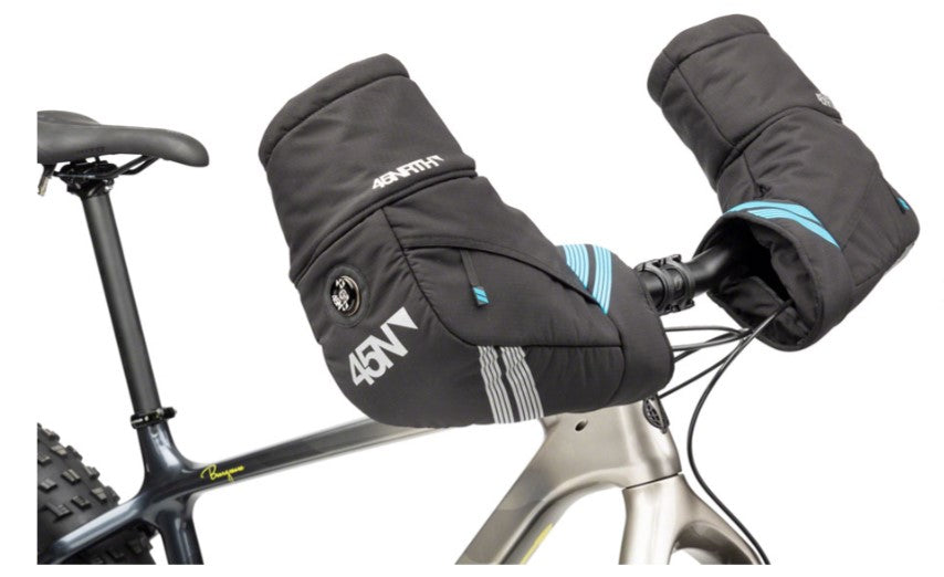 Side view of a pair of 45NRTH Cobrafist pogies installed on a silver bicycle. 