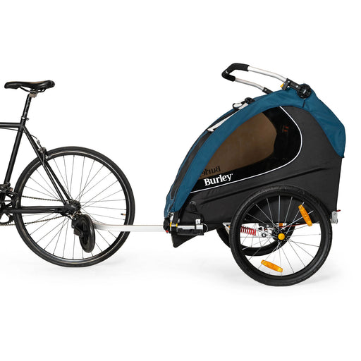 Burley Encore X Child Trailer Blue in trailer configuration being towed by a bike studio image side view