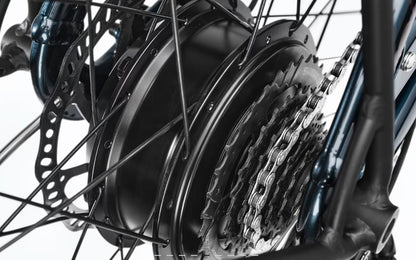 Close-up of a bicycle wheel with a hub drive motor, chain, and gear system on a white background