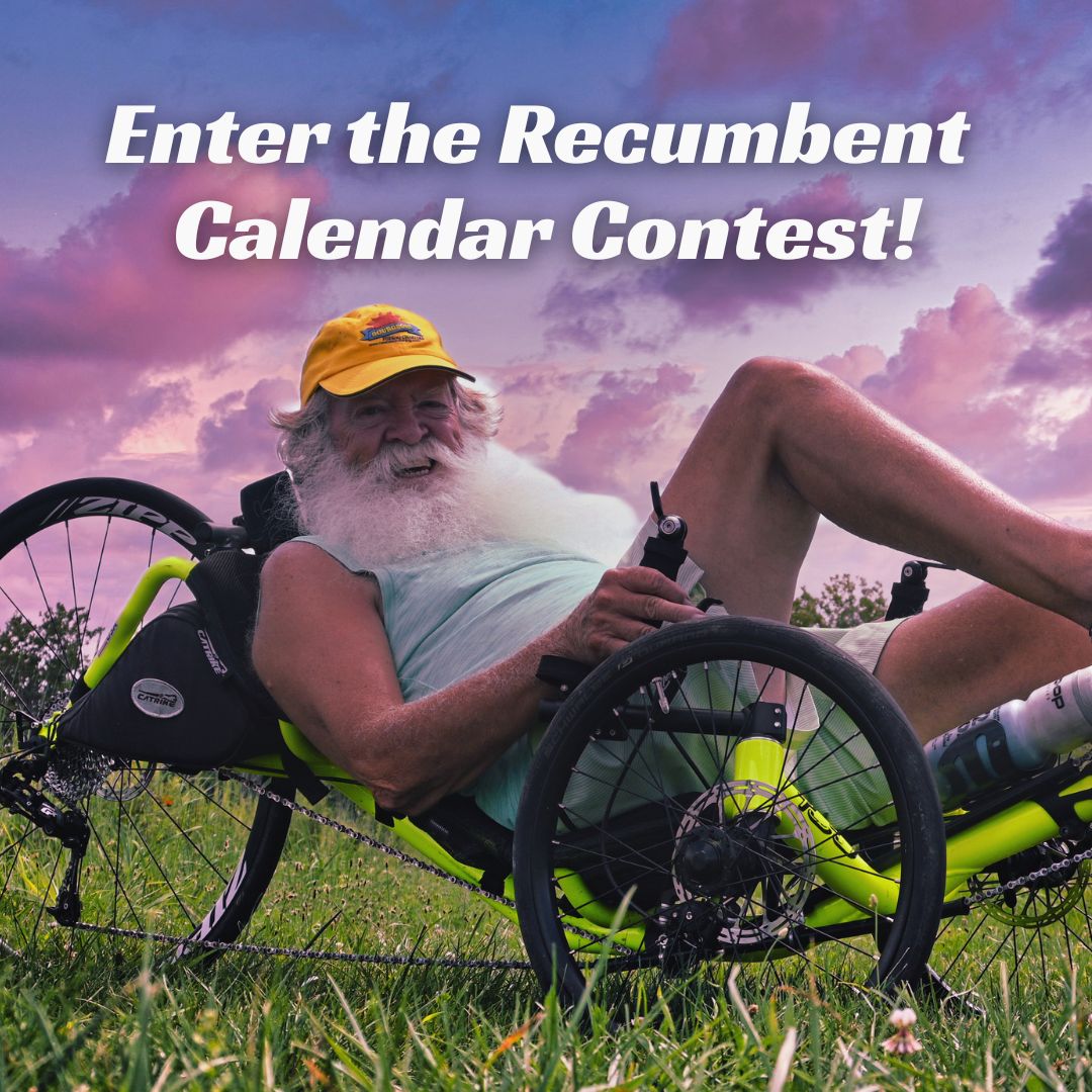 Man in a yellow cap sitting on a recumbent trike with a scenic background and overlay text that reads "enter the recumbent calendar contest!"