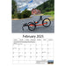 February 2025 Features an orange 
Greenspeed trike in the mountains in Washington in front of a red barn. 