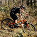 Mountain bike rider riding on trail with Fidlock twist 600 bottle attached to bike using Fidlock twist bike mount