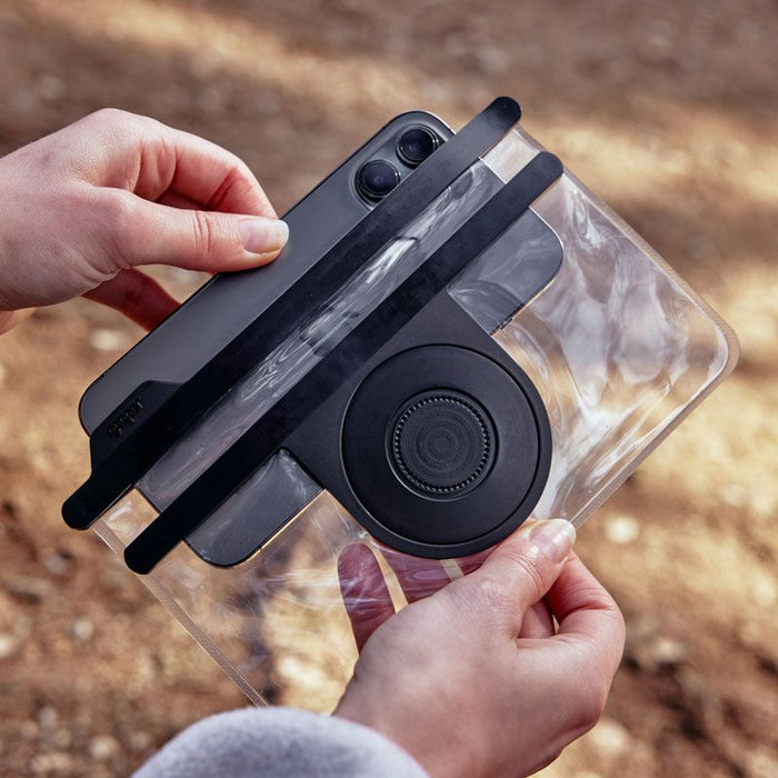Fidlock VACUUM Universal Phone Case L with phone being put inside outdoor photo