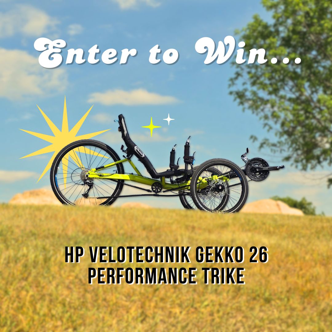 HP Velotechnik Gekko 26 Performance Trike in a field with 'Enter to Win' text above.