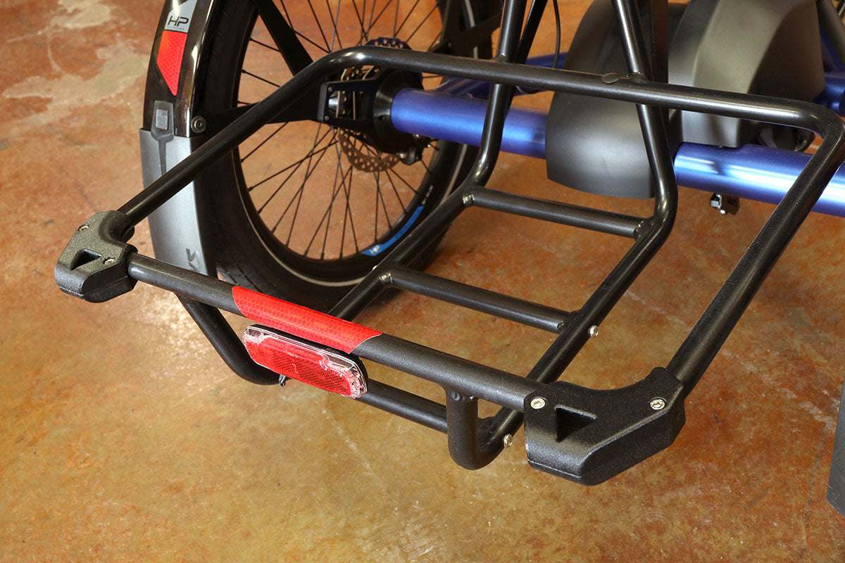 Image of black stand-up feet installed onto the basket of an HP Velotechnik Delta trike. 