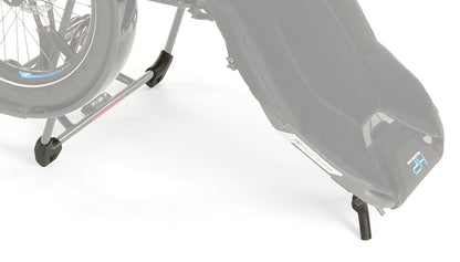 Studio image of a close up side view of the HP Velotechnik stand-up feet kit installed onto the back of the seat and back of the rack of a HP Velotechnik Delta trike. 