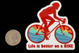 Hostel Shoppe Life Is Better On A Bike Decal studio image with quarter for scale