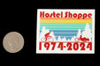 Hostel Shoppe 50th Anniversary Bike and Trike Decal next to a quarter