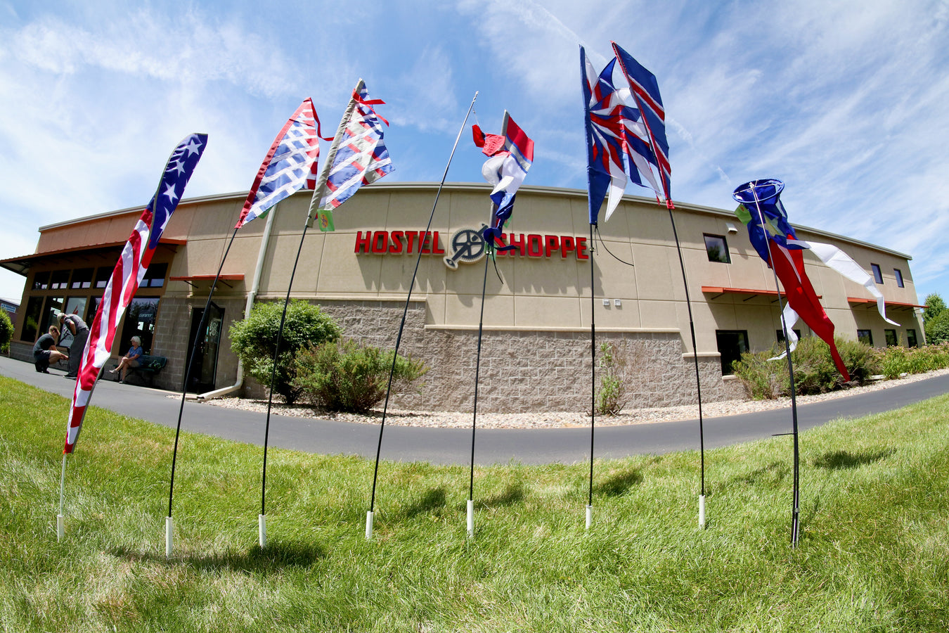 Patriotic bike flags lined up on the lawn in front of Hostel Shoppe.