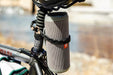 Modl 8" Infinity Tools 4 Pack black being used to secure a bluetooth speaker to a bicycle seat stem