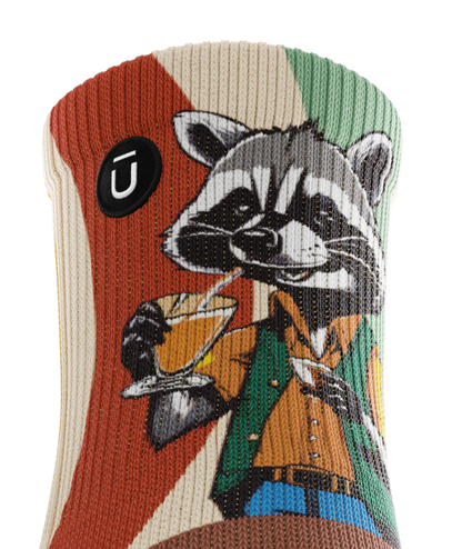 Top cuff view of  a multicolored  sock with racoon wearing brown button down shirt and green vest drinking cups of coffee. Small black circular logo with Outway logo near top of cuff. 