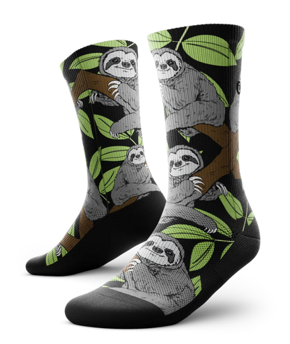 Pair of socks with grey sloths in trees with black background and soles