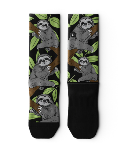 Pair of socks laying flat with grey sloths in trees with black background and soles