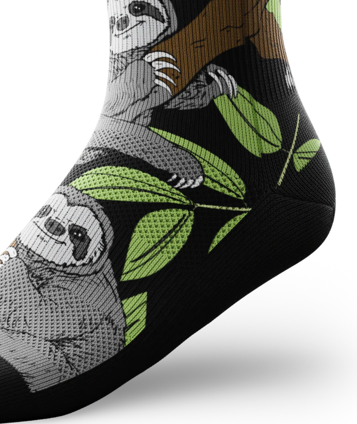 Side ankle view of sock with sloths in trees on main part of sock