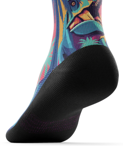Bottom sole of multicolored  sock with T-rex dinosaurs and palm trees on main part of sock