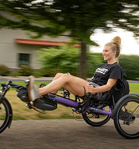 Girl riding Hase Kettwiesel Recumbent Trike