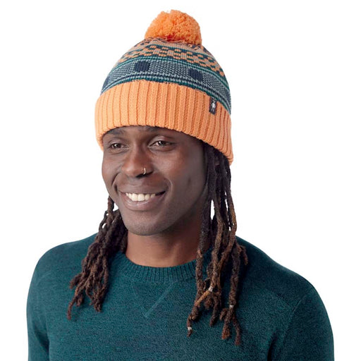 Smartwool Fairisle Fleece Lined Beanie in Apricot, studio front quarter view, with model