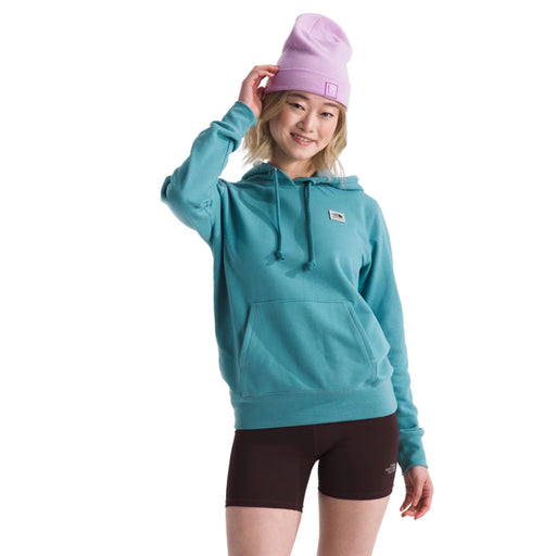 The North Face Womens Heritage Patch Pullover Hoodie Algae Blue/Heritage Patch, studio front view