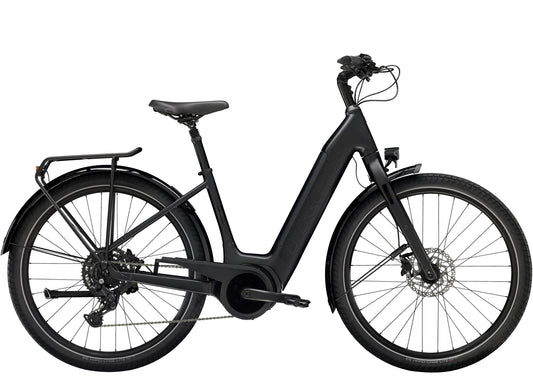 Side view of the Trek Verve+ 3 Lowstep Gen 3 e-Bike in Black, shown on a white background. It includes fenders, lights, rear rack, suspension seatpost, and kickstand.