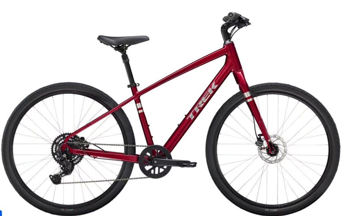 Red Trek Verve bicycle with silver 'Trek' branding on a white background.