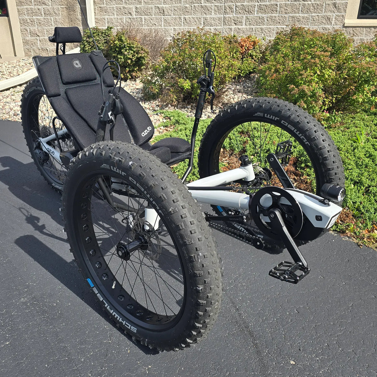 Angled side view of the Azub Demo Fat Bosch Performance CX Dynamic Grey Recumbent Trike in an outdoor setting.