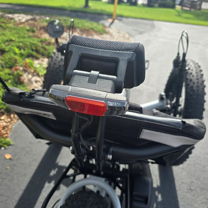 Closeup view of the taillight and neckrest on the Azub Demo Fat Bosch Performance CX Dynamic Grey Recumbent Trike in an outdoor setting.
