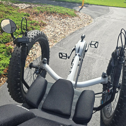 Closeup view of the mirror, handlebars and controls on the Azub Demo Fat Bosch Performance CX Dynamic Grey Recumbent Trike in an outdoor setting.