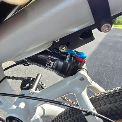 Closeup view of the rear Fox Float shock on the Azub Demo Six Bosch Performance CX Dynamic Grey Recumbent Bike in an outdoor setting.