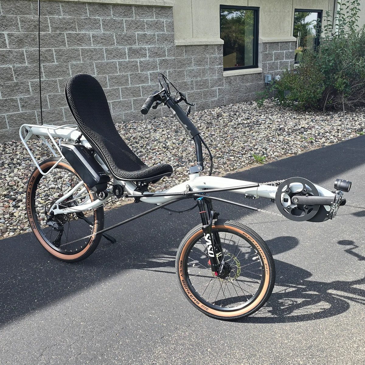 Angled side view of the Azub Demo Six Bosch Performance CX Dynamic Grey Recumbent Bike in an outdoor setting.