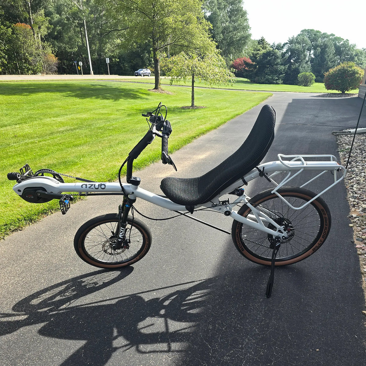 Non-drive side view of the Azub Demo Six Bosch Performance CX Dynamic Grey Recumbent Bike in an outdoor setting.