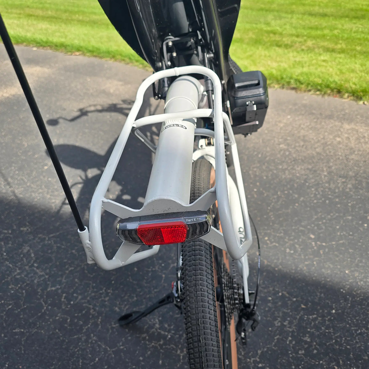 Closeup view of the rear rack and taillight on the Azub Demo Six Bosch Performance CX Dynamic Grey Recumbent Bike in an outdoor setting.
