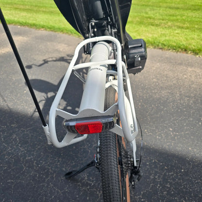 Closeup view of the rear rack and taillight on the Azub Demo Six Bosch Performance CX Dynamic Grey Recumbent Bike in an outdoor setting.