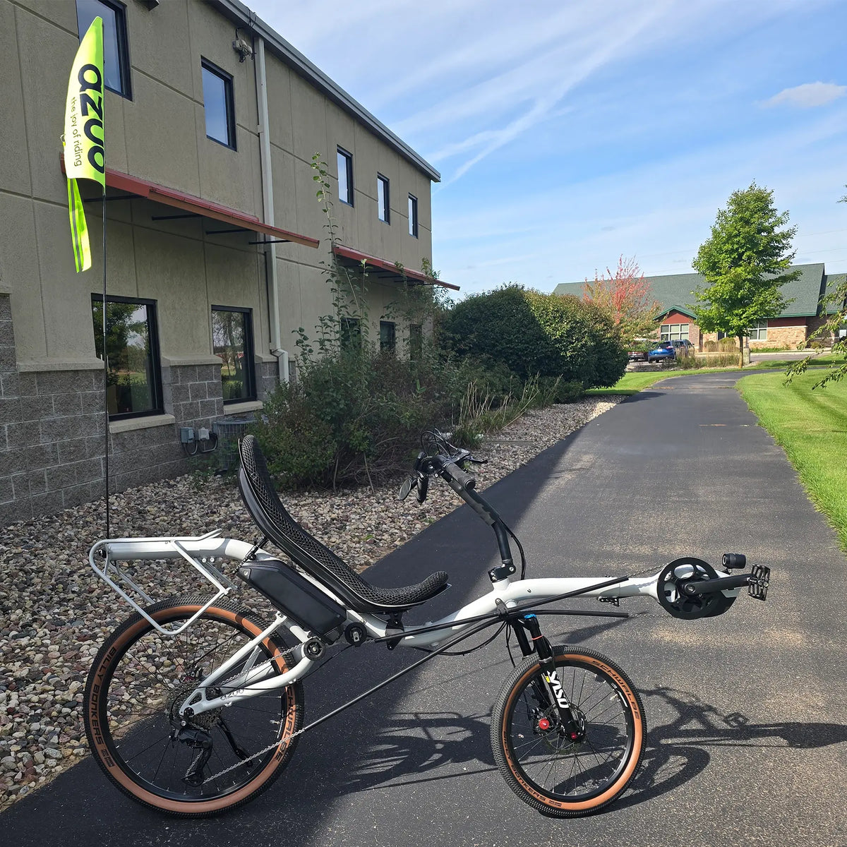 Side view of the Azub Demo Six Bosch Performance CX Dynamic Grey Recumbent Bike in an outdoor setting.