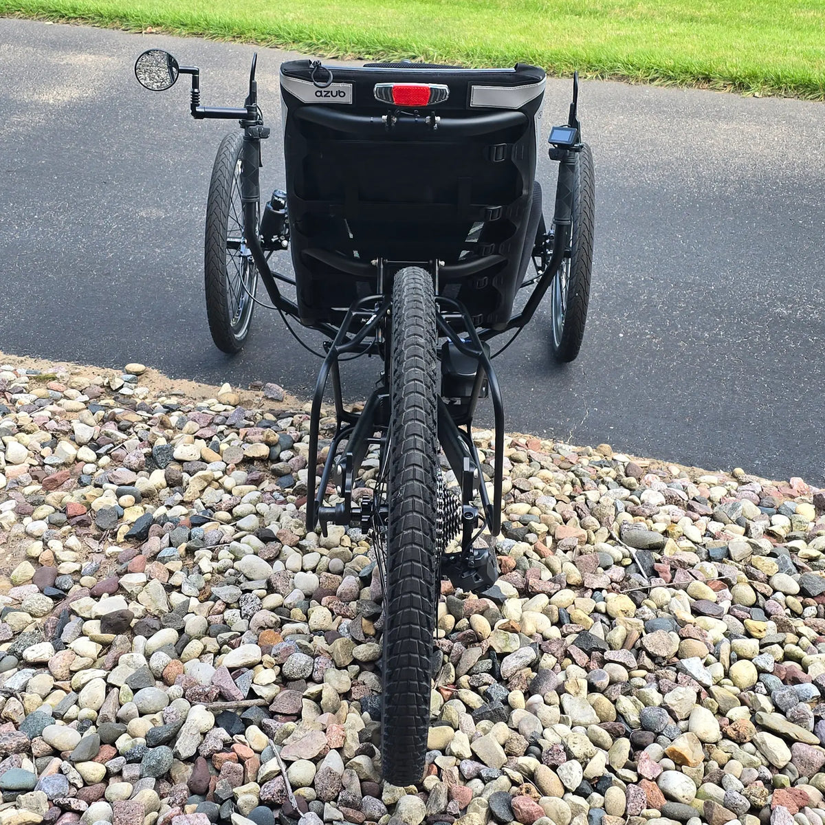 Rear view of the Azub Demo Ti-Fly 26 Shimano EP6 Deep Black Recumbent Trike in an outdoor setting.