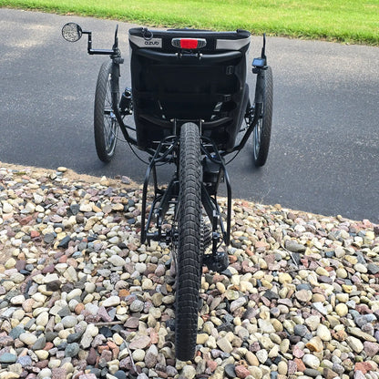 Rear view of the Azub Demo Ti-Fly 26 Shimano EP6 Deep Black Recumbent Trike in an outdoor setting.